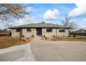 Traditional brick home with a well-kept front lawn and inviting walkway on a sunny day at 6690 S Sheridan Blvd, Littleton, CO 80123