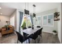 Stylish dining room with a modern table, elegant chairs, and natural light from windows and a sliding door at 9603 Dunning Cir, Highlands Ranch, CO 80126