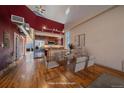 Dining area open to kitchen with stainless appliances and wood floors, blending cooking and dining creating a social ambiance at 190 Roslyn St # 802, Denver, CO 80230
