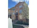 Charming brick townhome with balcony and blooming tree, showcasing a well-maintained facade and welcoming entrance at 190 Roslyn St # 802, Denver, CO 80230