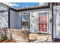 The front door is sheltered by a small porch with a decorative door and side window at 4401 Quieto Ct, Denver, CO 80211