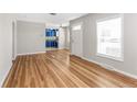 Bright living room featuring refinished hardwood floors and views into the kitchen at 4401 Quieto Ct, Denver, CO 80211