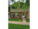 Charming townhouse with a well-maintained lawn and a cozy front porch at 604 S Xenon Ct, Lakewood, CO 80228