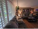 Spacious living room featuring a large sectional sofa and ample natural light at 604 S Xenon Ct, Lakewood, CO 80228