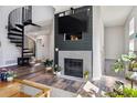 Comfortable living area with a fireplace, spiral staircase, and an abundance of natural light at 8707 E Florida Ave # 814, Denver, CO 80247