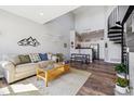 Bright, open-concept living room with hardwood floors, modern décor, and a unique spiral staircase at 8707 E Florida Ave # 814, Denver, CO 80247