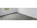 Neutral bedroom with gray carpet, white walls, and a bright window at 17115 W 91St Ln, Arvada, CO 80007