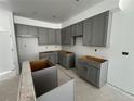 Spacious kitchen features gray cabinets and ample space for customization at 17115 W 91St Ln, Arvada, CO 80007