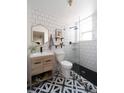 Modern bathroom with subway tile, a glass-enclosed shower, and a patterned tile floor at 215 E 11Th Ave # A5, Denver, CO 80203