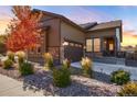 Two-story home with a charming front porch and beautiful fall foliage at 521 Garden Sage Ct, Castle Rock, CO 80104