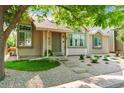 A charming exterior view of a well-maintained home with front yard landscaping and mature trees at 98 N Quicksilver Ave, Castle Rock, CO 80104