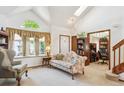 Bright living room with a vaulted ceiling, floral sofa, and open access to the study and staircase at 98 N Quicksilver Ave, Castle Rock, CO 80104