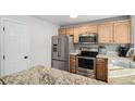 Spacious kitchen featuring stainless steel appliances and granite countertops at 4695 S Lowell Blvd, Denver, CO 80236
