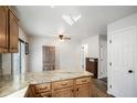 Bright kitchen view showcasing granite countertops and wood-look flooring at 4695 S Lowell Blvd, Denver, CO 80236