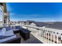 Relaxing deck area with outdoor furniture, fire table, and neighborhood views at 2153 Abigail Ln, Castle Rock, CO 80104