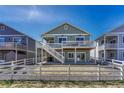 Back exterior view showing a deck and stairs with a fenced yard and patio at 2153 Abigail Ln, Castle Rock, CO 80104