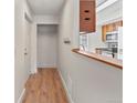 Inviting entryway featuring wood floors, coat closet, and a breakfast bar to the kitchen at 865 S Quebec St # 101B, Denver, CO 80247