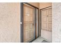 Inviting entrance featuring neutral-toned doors with unit numbers, doorbell, and secure screen doors at 865 S Quebec St # 101B, Denver, CO 80247