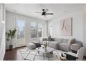 Bright living room with a modern ceiling fan, plush seating, and stylish geometric rug at 12270 Karls Ln, Northglenn, CO 80241