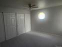 Bright bedroom features natural light, a ceiling fan, and double closets at 12148 Melody Dr # 108, Denver, CO 80234