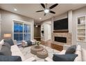 Comfortable living room with fireplace and sliding glass doors, offering a bright and airy space for relaxation at 3703 New Haven Cir, Castle Rock, CO 80109