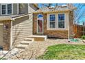 Inviting entrance with brick accents and a well-maintained walkway at 5826 S Jebel Way, Centennial, CO 80015
