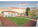 Quaint single-story home featuring lush green grass, a tidy yard, and a charming light-blue front door at 3630 Magnolia St, Denver, CO 80207
