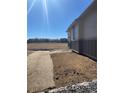 Backyard showing the grading and seeding prep with view of the community at 16622 E 109Th Ave, Commerce City, CO 80022