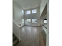 Bright, open living area with soaring ceilings, large windows, and hardwood flooring at 2197 S Jackson Gap St, Aurora, CO 80018