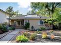 Well-kept home displaying a landscaped front yard featuring rocks, plants, walkway, and a cozy porch at 1275 Fairfax St, Denver, CO 80220