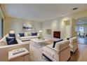 Bright living room featuring a modern fireplace and stylish white furniture at 1275 Fairfax St, Denver, CO 80220