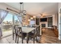 Open dining area featuring modern lighting, a view to the living room, and sliding glass doors to the backyard at 12362 Nate Cir, Parker, CO 80134