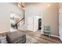 Open-concept living area with staircase, laundry room, and dining room views at 12362 Nate Cir, Parker, CO 80134