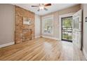 Inviting room featuring an exposed brick accent wall and ample natural light at 709 27Th St, Denver, CO 80205