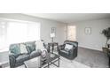 Inviting living room with large bay window, comfortable seating, and neutral-toned walls at 1409 S Moline St, Aurora, CO 80012