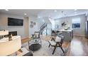 Open living room with kitchen and staircase views, hardwood floors, and fireplace at 2176 S Birch St, Denver, CO 80222