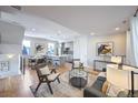 Open-concept living space showcasing kitchen and living area with hardwood floors at 2176 S Birch St, Denver, CO 80222