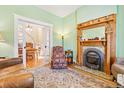 Comfortable living room featuring a classic fireplace and hardwood floors at 4054 Wyandot St, Denver, CO 80211