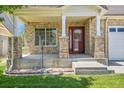 Inviting front porch with brick pillars and a glass-paneled door, creating a warm welcome to the home at 5131 Netherland St, Denver, CO 80249