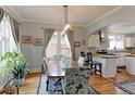 Inviting dining room with hardwood floors, archway to the kitchen and lots of natural light at 1434 Osceola St, Denver, CO 80204