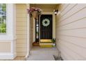 Close-up of the front door, adorned with a decorative wreath, and hanging flower basket at 527 English Sparrow Trl, Highlands Ranch, CO 80129