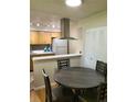 Bright dining area with a round table next to the kitchen and great natural light at 9105 E Lehigh Ave # 105, Denver, CO 80237