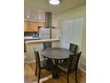 Cozy dining area featuring a round table and chairs, adjacent to the kitchen for easy access at 9105 E Lehigh Ave # 105, Denver, CO 80237