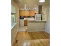 Well-lit kitchen features wood floors, stainless steel appliances, and ample counter space at 9105 E Lehigh Ave # 105, Denver, CO 80237
