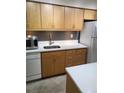 Modern kitchen with updated marble-style countertops, wooden cabinets and stainless steel appliances at 9105 E Lehigh Ave # 105, Denver, CO 80237