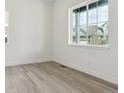 Bright bedroom with large windows and modern light gray flooring at 8245 Cokedale Cir, Littleton, CO 80125