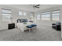 Bright and airy main bedroom with plush carpeting and scenic outdoor views from the large windows at 953 Compass Dr, Erie, CO 80516