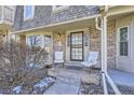 Brick townhouse with a front porch and two chairs at 7725 S Cove Cir, Centennial, CO 80122