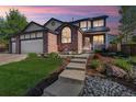 Charming two-story brick home with a three car garage, landscaped yard, and a cozy front porch at 1300 W 13Th Ave, Broomfield, CO 80020