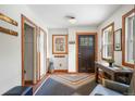 Bright entryway with coat rack, sitting area, and tiled floor at 65 Cottonwood Dr, Evergreen, CO 80439